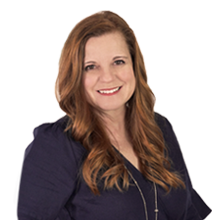 Portrait of a smiling Amy Roush wearing professional clothes